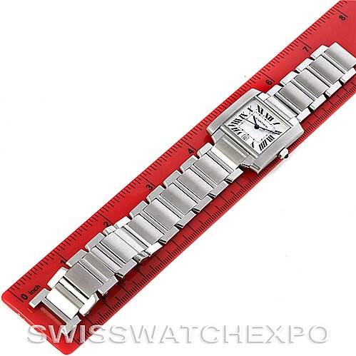The image shows a Cartier Tank Francaise W51002Q3 Men's Stainless Steel Silver Dial W51002Q3 Men's Stainless Steel Silver Dial watch laid flat alongside a red ruler, displaying the bracelet and face.