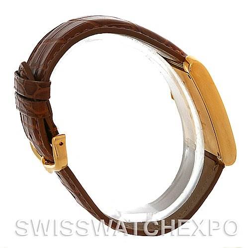 This image shows a side view of the Cartier Tank Francaise W5000556 Men's Yellow Gold Silver Dial W5000556 Men's Yellow Gold Silver Dial watch, highlighting its brown leather strap and gold case.