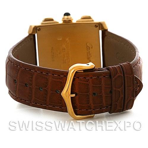 The image shows the back view of a Cartier Tank Française watch, focusing on the gold case and brown leather strap with a gold buckle.