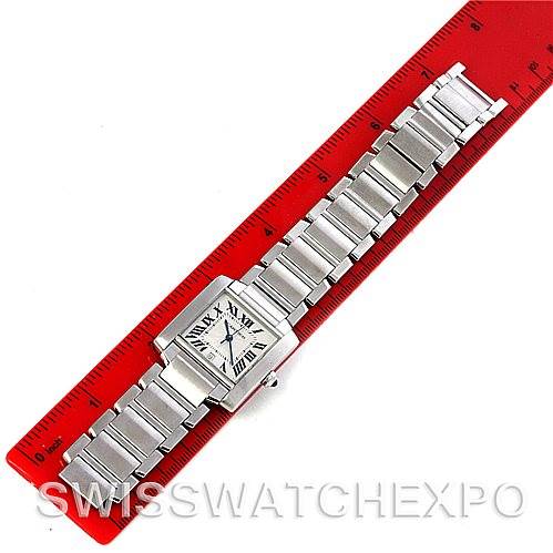 The Cartier Tank Francaise W51002Q3 Men
s Stainless Steel Silver Dial W51002Q3 Men
s Stainless Steel Silver Dial watch is shown from a top-down angle, displaying the face, bracelet, and clasp against a red ruler for scale.