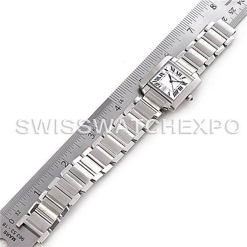 This image shows the Cartier Tank Francaise W51002Q3 Men's Stainless Steel Silver Dial W51002Q3 Men's Stainless Steel Silver Dial watch laid flat next to a ruler, displaying its face and bracelet.