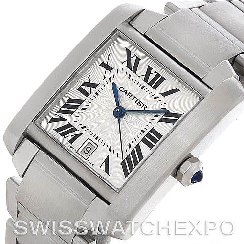 The image shows a close-up, angled view of a Cartier Tank Française watch face, including its bracelet, crown, and date window.