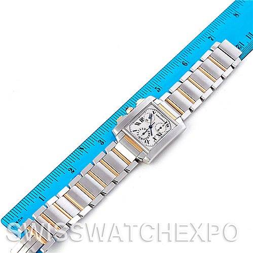 The image shows a Cartier Tank Francaise W51004Q4 Men's Steel and Gold (two tone) Silver Dial W51004Q4 Men's Steel and Gold (two tone) Silver Dial watch laid flat next to a blue ruler to indicate size and measurements.