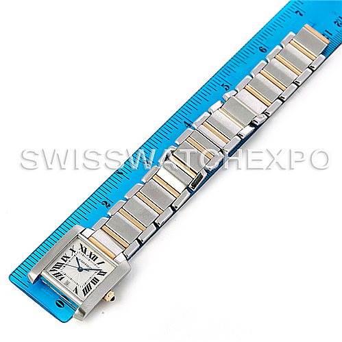 The image shows a top-down view of the Cartier Tank Francaise W51005Q4 Men's Steel and Gold (two tone) Silver Dial W51005Q4 Men's Steel and Gold (two tone) Silver Dial watch, displaying its face and entire bracelet on a blue ruler.