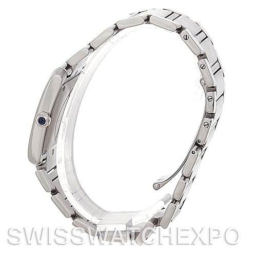 The image shows a side view of a Cartier Tank Française watch, highlighting the case, bracelet, and crown with a blue gem.