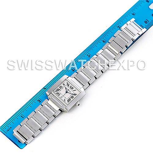 The image shows a top-down view of a Cartier Tank Francaise W51002Q3 Men's Stainless Steel Silver Dial W51002Q3 Men's Stainless Steel Silver Dial watch placed next to a blue ruler for size reference.