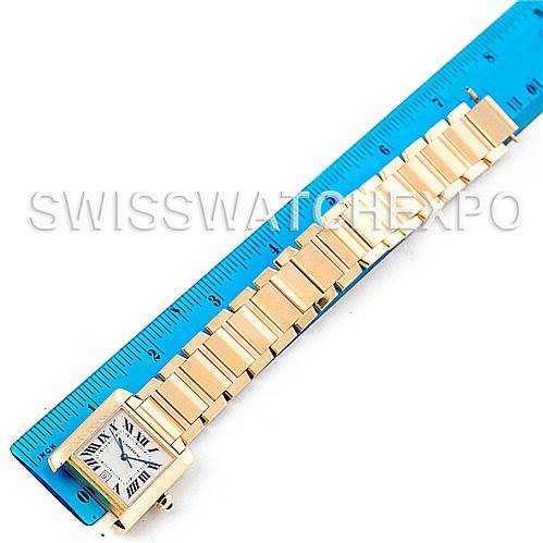 The image shows a Cartier Tank Francaise W50001R2 Men's Yellow Gold Silver Dial W50001R2 Men's Yellow Gold Silver Dial watch with a ruler, displaying its face and bracelet from a top-down angle.