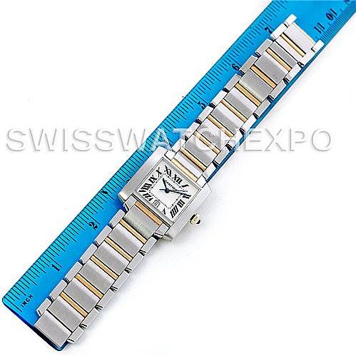 The image shows a Cartier Tank Française watch laid flat against a ruler, displaying the watch face, bracelet, and crown.