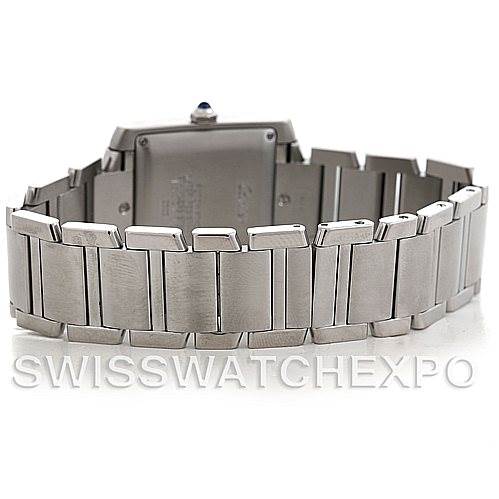 The image shows a rear angle of the Cartier Tank Française, highlighting its stainless steel bracelet and case back.
