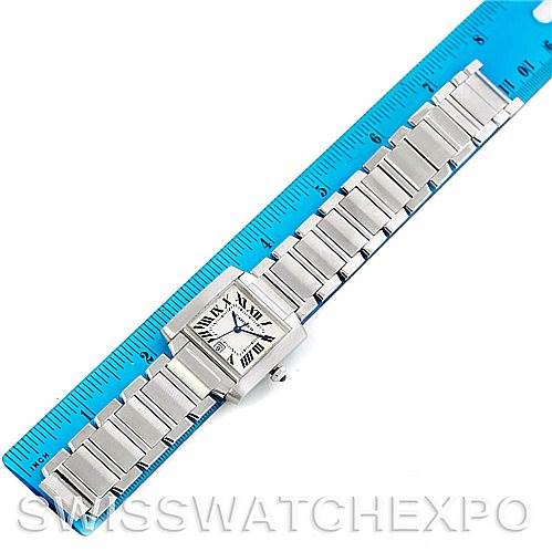 The image shows a top-down view of a Cartier Tank Francaise W51002Q3 Men
s Stainless Steel Silver Dial W51002Q3 Men
s Stainless Steel Silver Dial watch, positioned next to a blue ruler for scale.