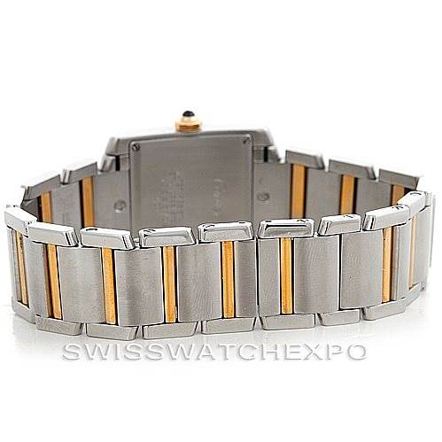 The image displays the back view of a Cartier Tank Française watch, highlighting its stainless steel and gold bracelet.