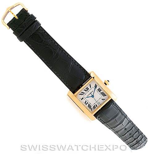 This image shows a top-down view of the Cartier Tank Francaise W5000156 Men's Yellow Gold Silver Dial W5000156 Men's Yellow Gold Silver Dial watch, featuring its black leather strap and rectangular face.