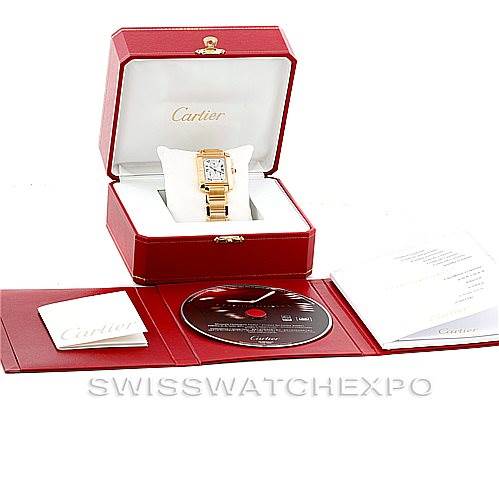 The Cartier Tank Francaise W50005R2 Men's Yellow Gold Silver Dial W50005R2 Men's Yellow Gold Silver Dial watch is shown in its open box, alongside manuals and a CD, viewed from the front.