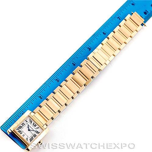 The image shows a top-down view of a Cartier Tank Francaise W50001R2 Men's Yellow Gold Silver Dial W50001R2 Men's Yellow Gold Silver Dial watch next to a blue ruler.