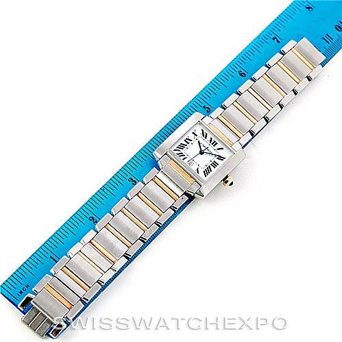 The Cartier Tank Française watch is shown laid flat with its face and bracelet fully visible, next to a blue ruler for size reference.