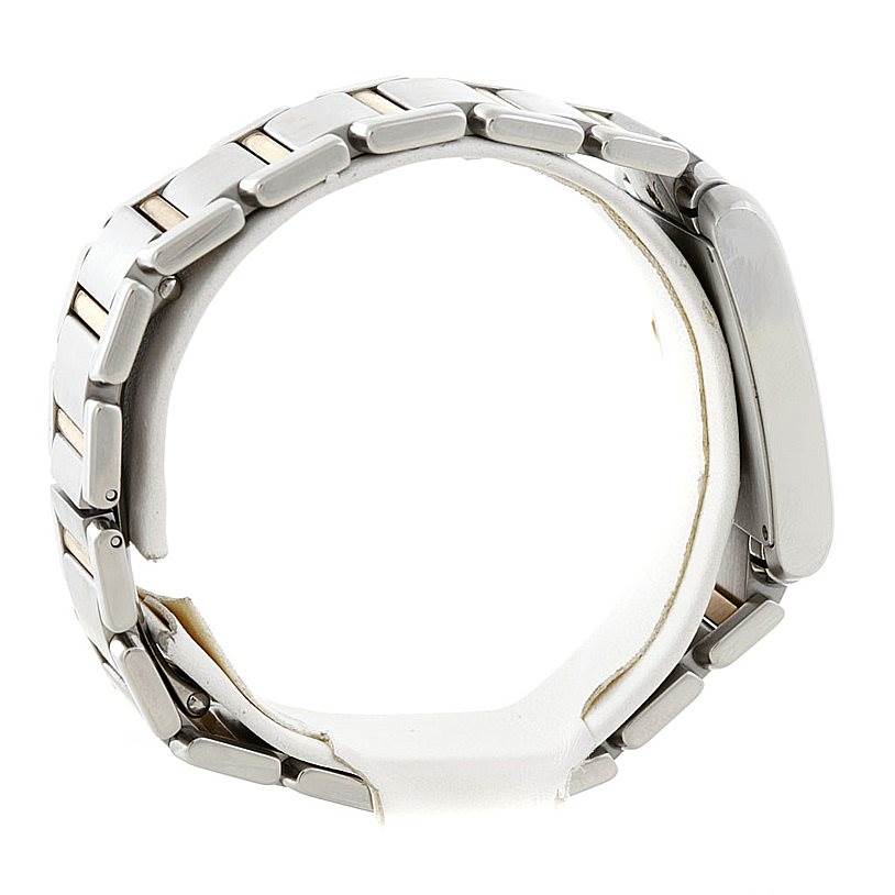 The Cartier Tank Française watch is shown from a side angle, focusing on its metal bracelet and clasp.