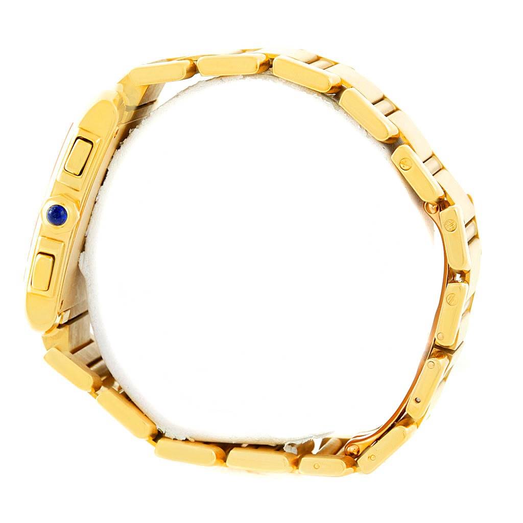 The image shows a side view of a Cartier Tank Française watch, highlighting its gold bracelet and crown with a blue cabochon.