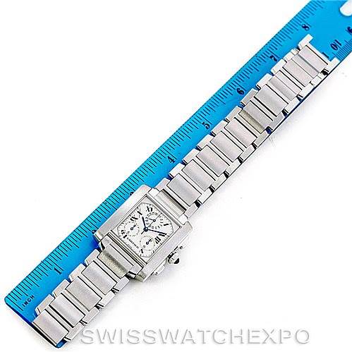 The image shows a Cartier Tank Francaise W51001Q3 Men's Stainless Steel White Dial W51001Q3 Men's Stainless Steel White Dial watch lying flat next to a blue ruler, showcasing its metal bracelet and square face.