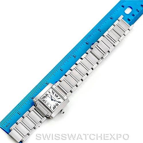 The Cartier Tank Francaise W51002Q3 Men
s Stainless Steel Silver Dial W51002Q3 Men
s Stainless Steel Silver Dial watch is displayed lying flat alongside a blue ruler, showcasing its full length and bracelet details.
