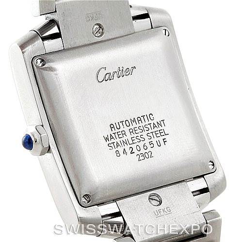 The image shows the back case and part of the bracelet of a Cartier Tank Française watch, highlighting the inscriptions and crown.