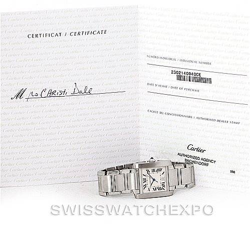 The image shows a Cartier Tank Française watch angled to display its face and band, alongside the watch
s certificate and paperwork.