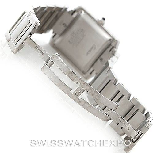 The image shows the back case and partially extended bracelet of a Cartier Tank Française watch.
