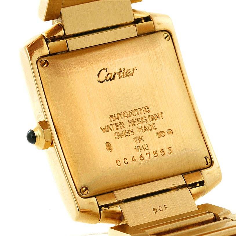 This image shows the back case and part of the bracelet of a Cartier Tank Française watch, highlighting its engravings.