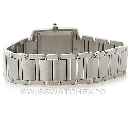 The image shows the backside of the Cartier Tank Française watch, highlighting its metal bracelet and caseback.