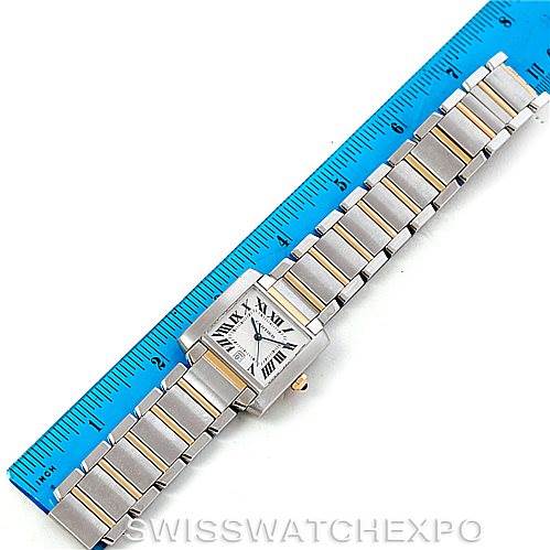 The Tank Française watch by Cartier is shown in a top-down view, measured against a blue ruler.