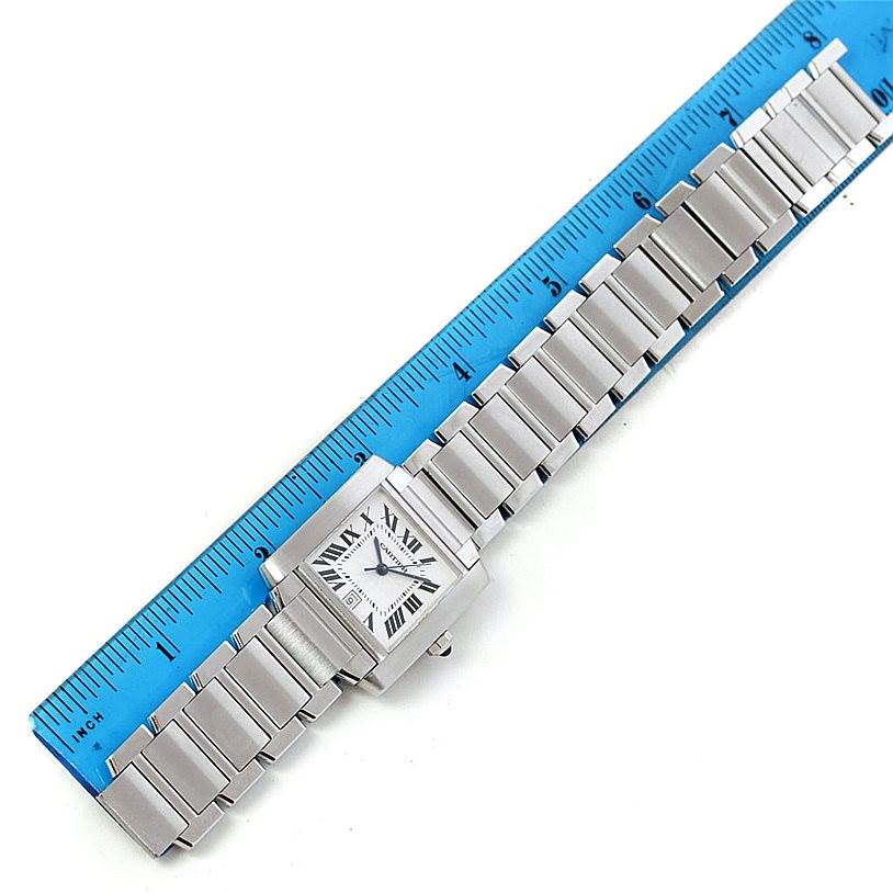 The Cartier Tank Francaise W51002Q3 Men
s Stainless Steel Silver Dial W51002Q3 Men
s Stainless Steel Silver Dial watch is shown from a top-down angle, including the entire band and face with a blue ruler for scale.