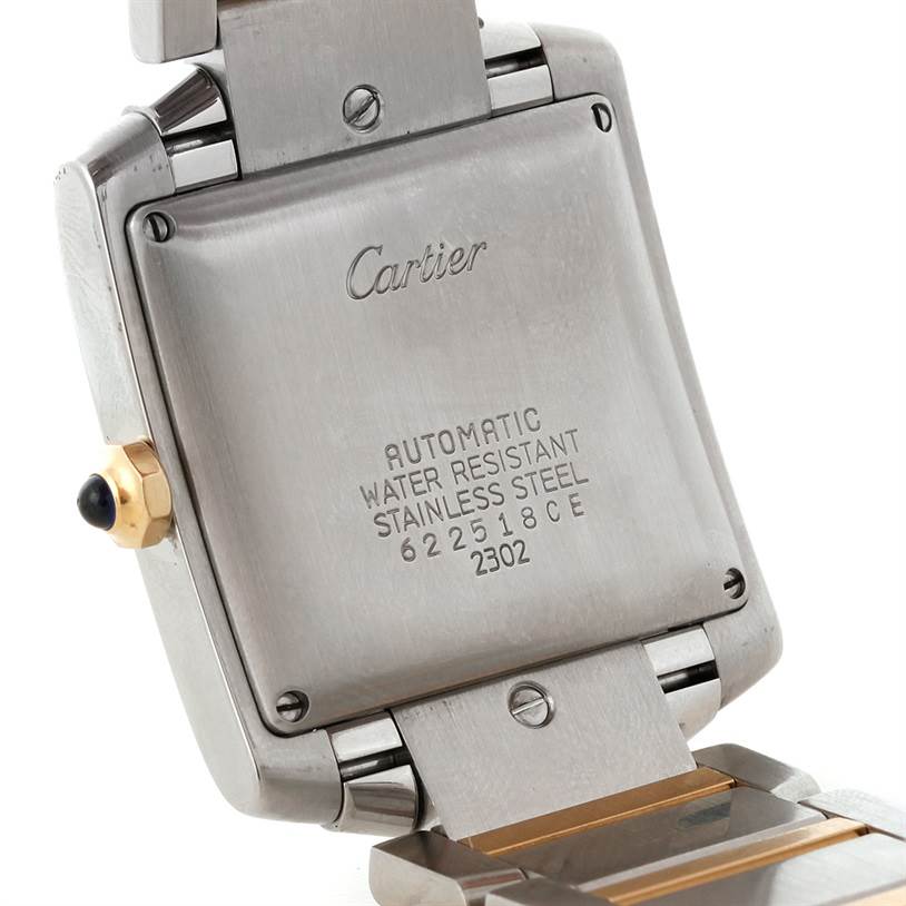The image shows the back casing and part of the strap of a Cartier Tank Française watch, displaying engraving details.