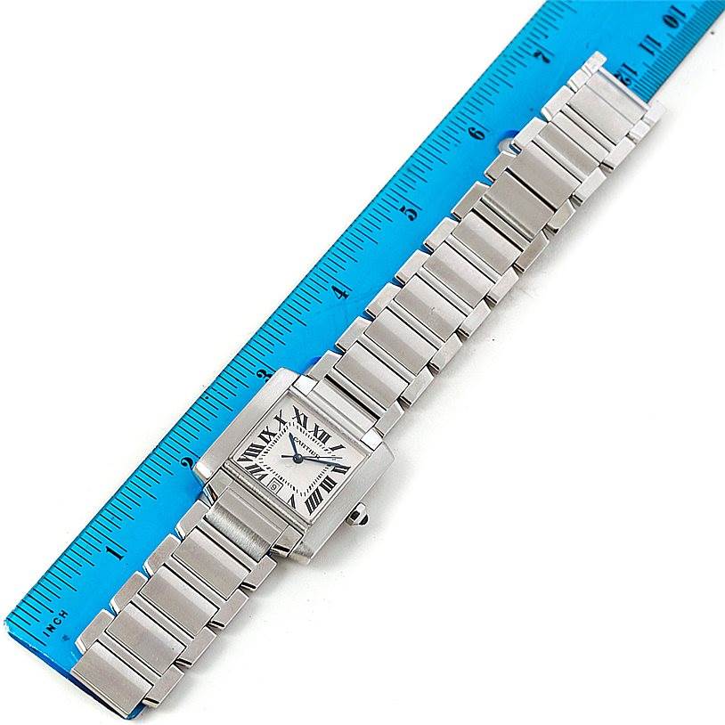 The Cartier Tank Francaise W51002Q3 Men's Stainless Steel Silver Dial W51002Q3 Men's Stainless Steel Silver Dial watch is shown face-up, displaying the dial and full metal bracelet with a ruler for scale.
