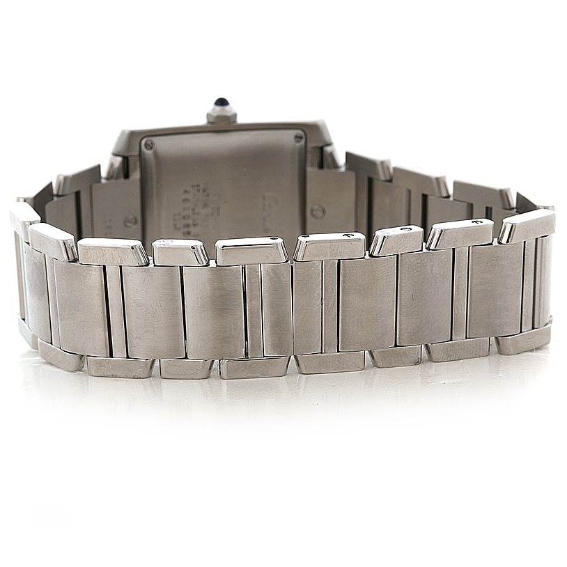 The image shows the back side and bracelet of a Cartier Tank Française watch, highlighting its metal links and closure.