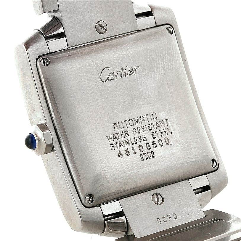 The image shows the back of a Tank Francaise watch by Cartier, highlighting the stainless steel case and markings.