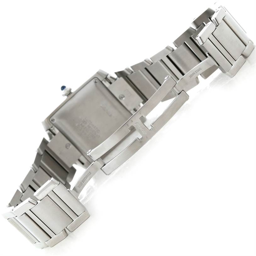 The image shows the back of a Cartier Tank Française watch, focusing on the stainless steel bracelet and clasp.