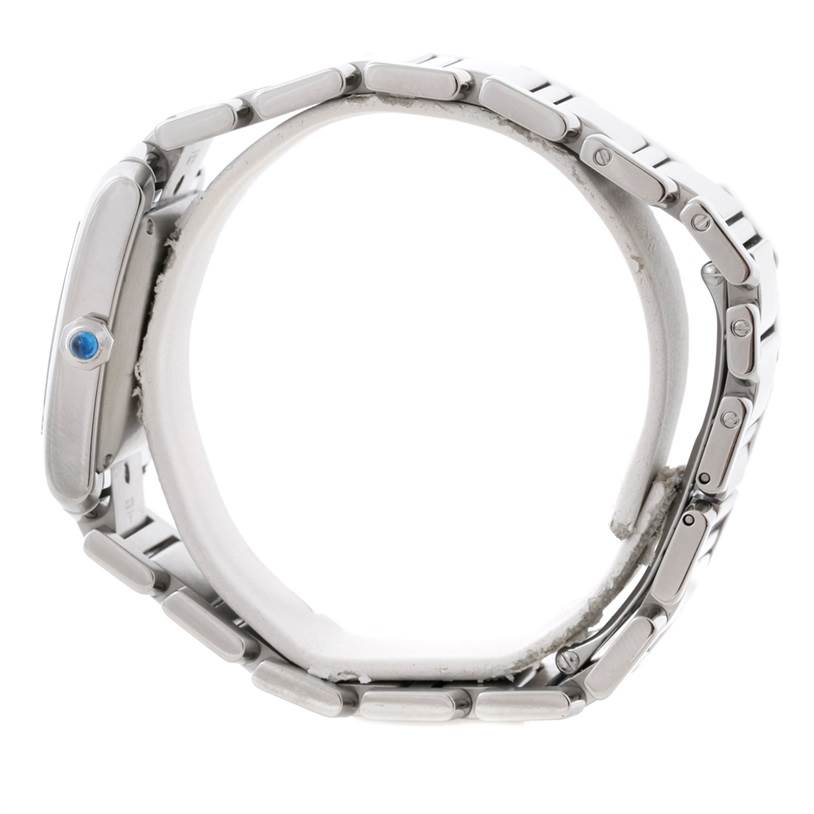 The side view of the Cartier Tank Française watch shows its stainless steel bracelet and blue crown.