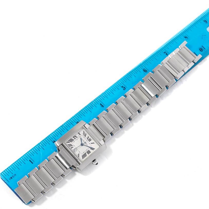 The Cartier Tank Francaise W51002Q3 Men's Stainless Steel Silver Dial W51002Q3 Men's Stainless Steel Silver Dial watch is shown flat, with its stainless steel bracelet extended alongside a blue ruler for scale.