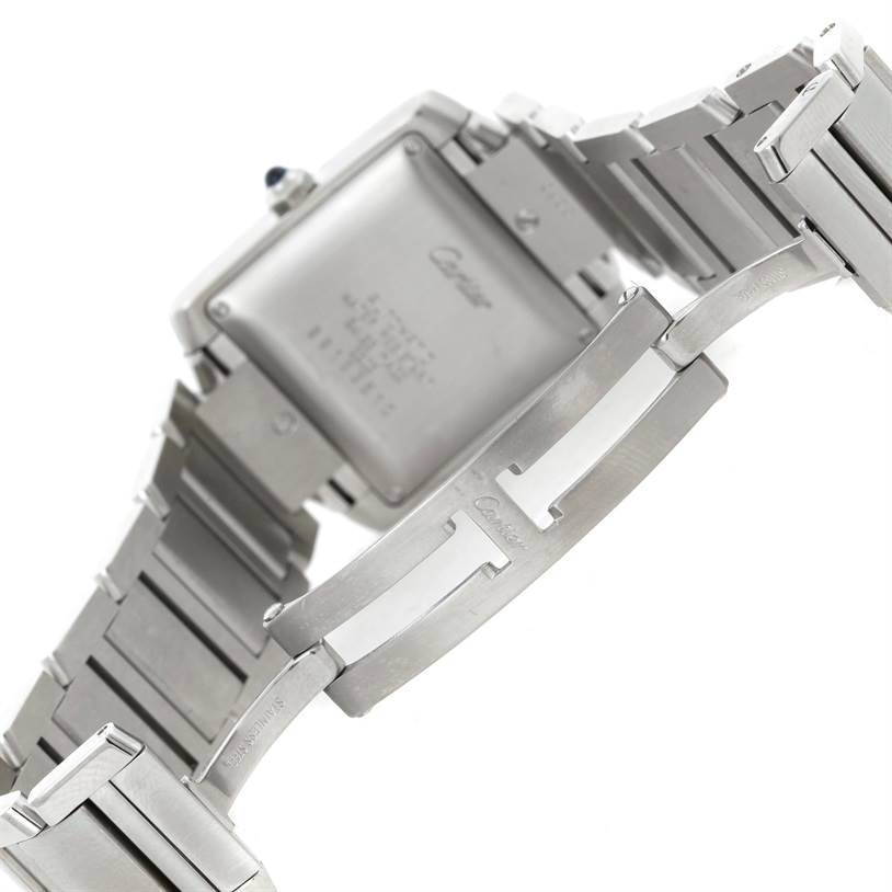 The image shows the back and bracelet of a Cartier Tank Française watch, emphasizing its stainless steel links and clasp.