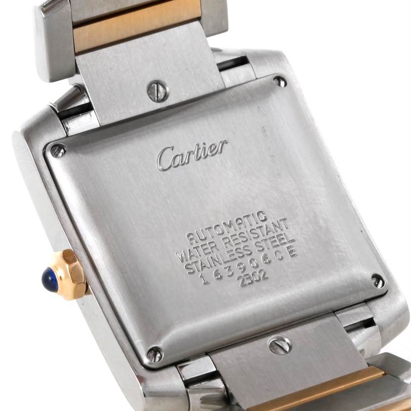 The image shows the back case and part of the strap of a Cartier Tank Francaise W51005Q4 Men's Steel and Gold (two tone) Silver Dial W51005Q4 Men's Steel and Gold (two tone) Silver Dial watch, displaying its brand engravings and crown.