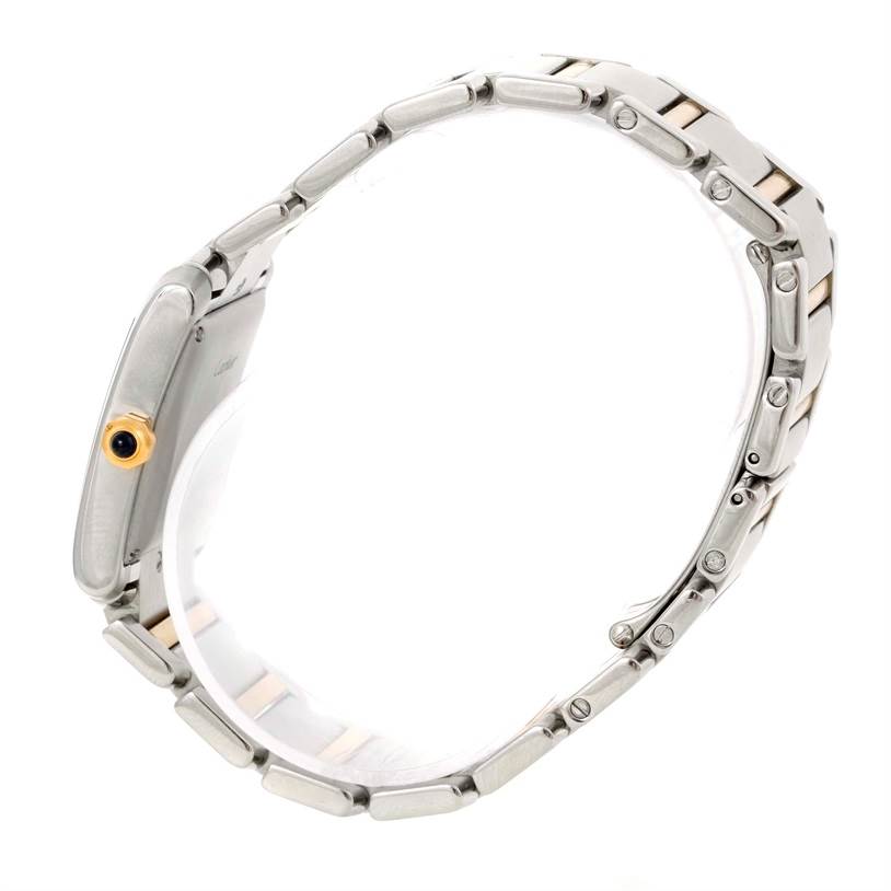 The image displays a Tank Française model by Cartier from a side angle, highlighting its metal bracelet and crown.