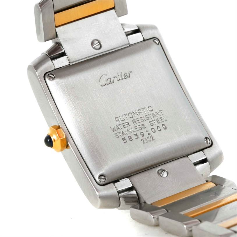 The image shows the back case and partial bracelet of a Cartier Tank Française watch, highlighting its inscriptions and crown.