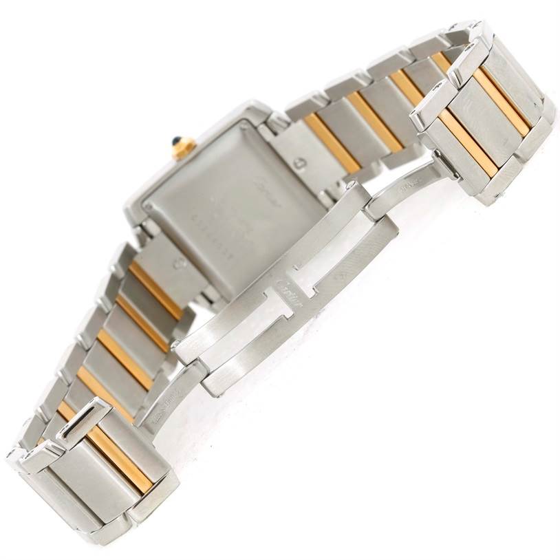 The image shows the back of a Cartier Tank Française watch and its metal bracelet, emphasizing the clasp and backside details.