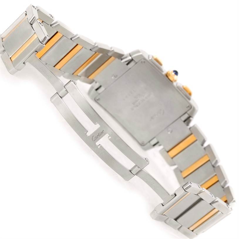 The image shows the backside and open clasp of a Cartier Tank Française watch, highlighting its two-tone metal bracelet.