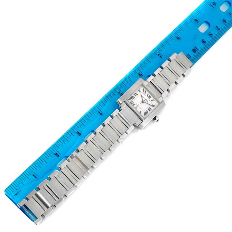 The Cartier Tank Francaise W51002Q3 Men
s Stainless Steel Silver Dial W51002Q3 Men
s Stainless Steel Silver Dial watch is shown from a top-down angle, lying flat beside a blue ruler for scale.