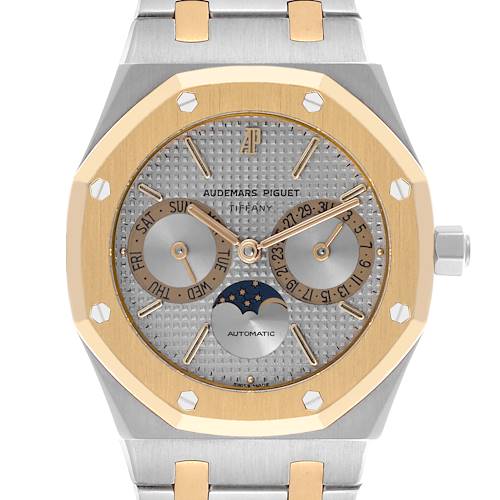 The Audemars Piguet Royal Oak watch is shown from the front, highlighting the dial with day, date, and moon phase features.