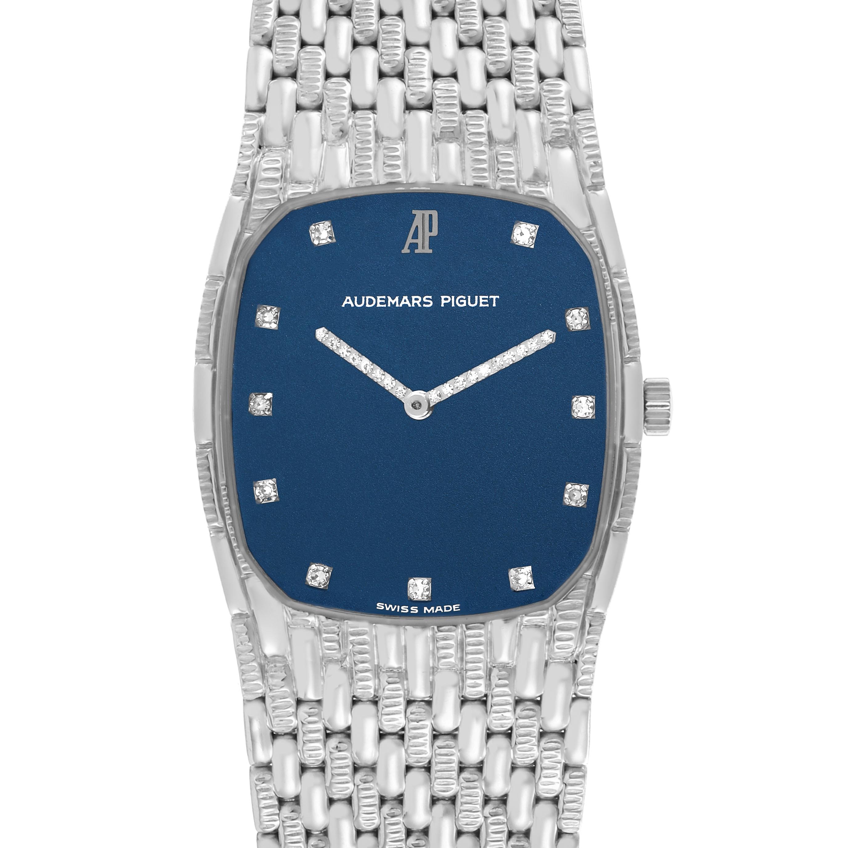 The Audemars Piguet Vintage Men's White Gold Blue Dial Men's White Gold Blue Dial watch is shown from a front angle, highlighting the blue dial, diamond markers, and woven bracelet.
