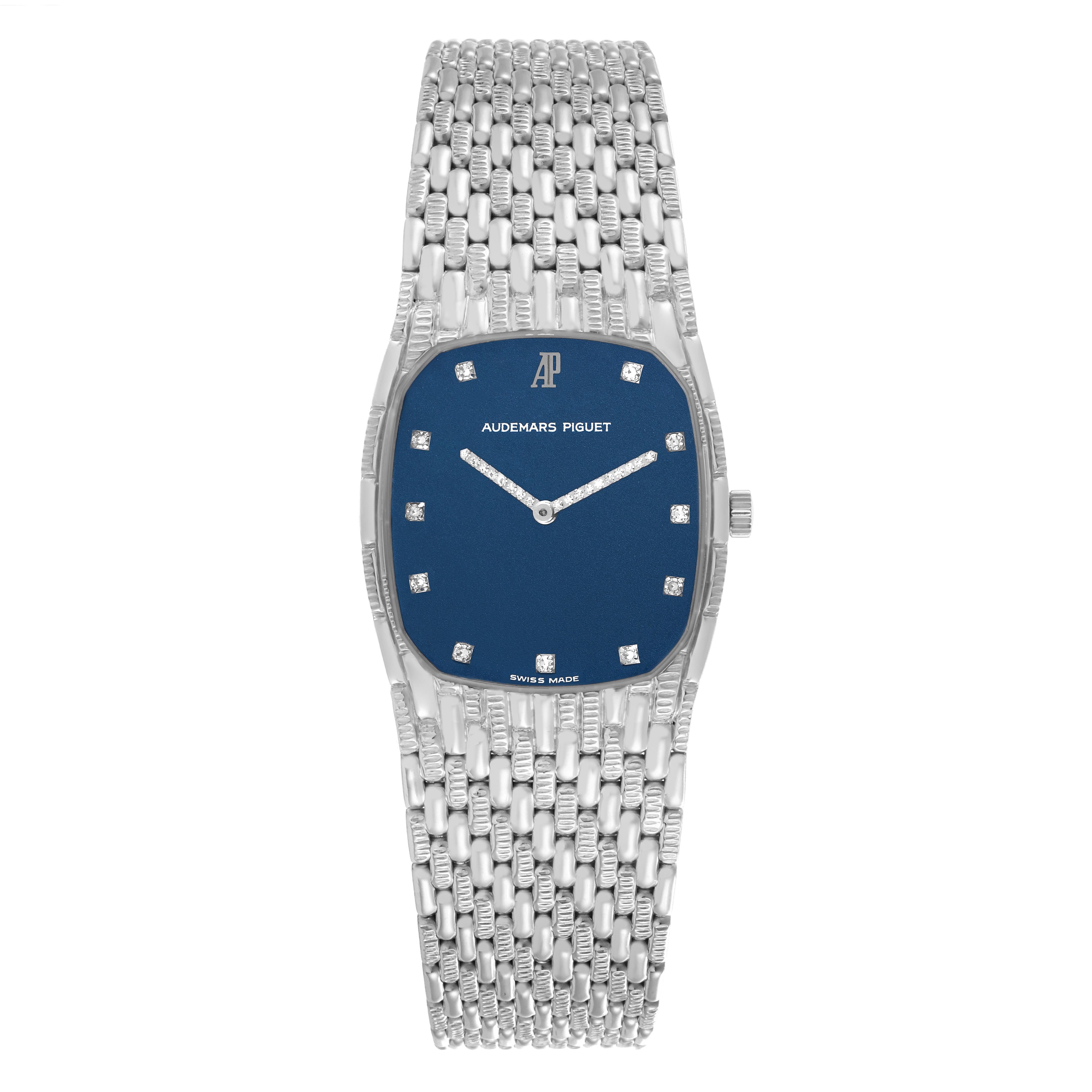 The Audemars Piguet Vintage Men's White Gold Blue Dial Men's White Gold Blue Dial watch is shown from a top-down angle, highlighting the blue dial, diamond indices, and woven bracelet.