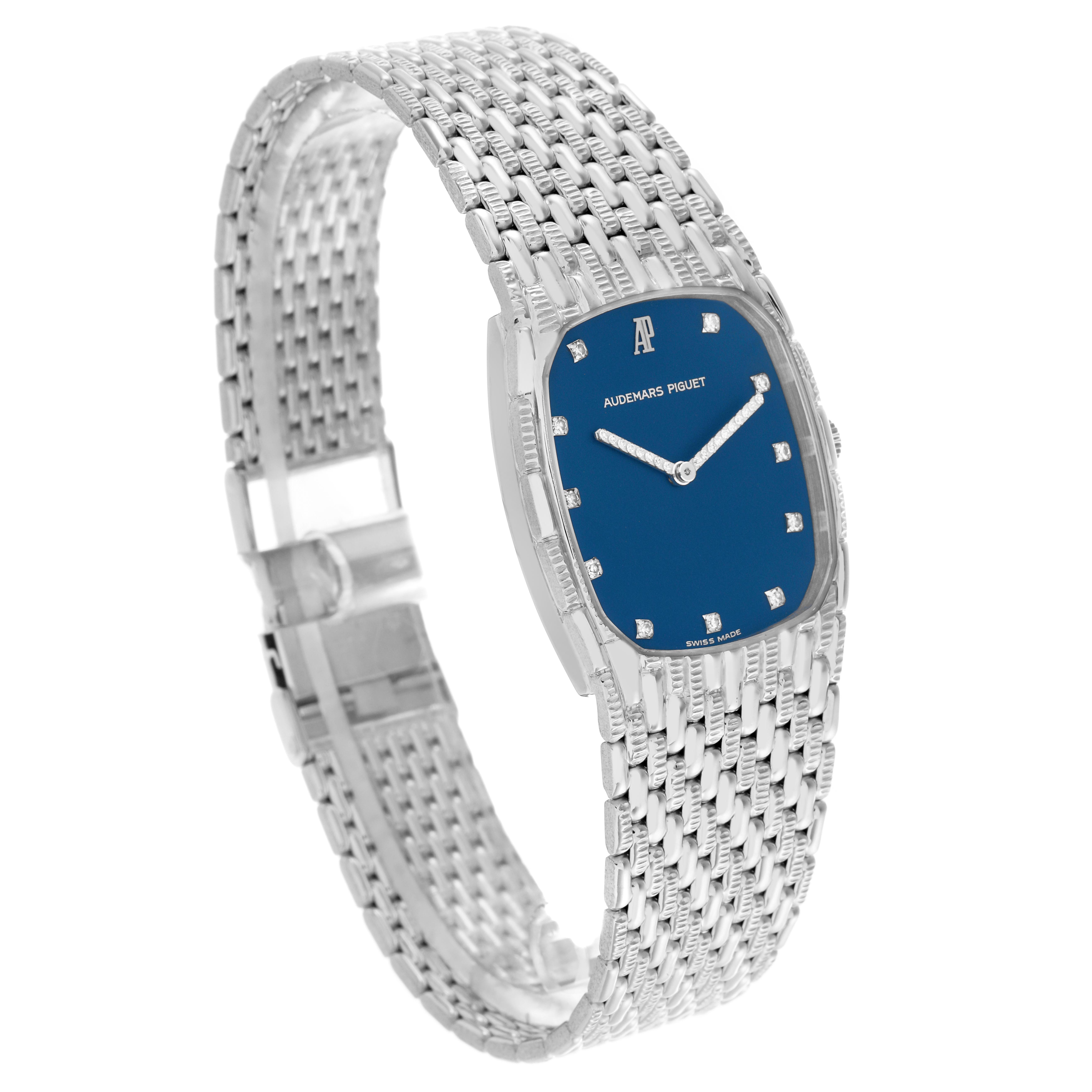 The Audemars Piguet Vintage Men's White Gold Blue Dial Men's White Gold Blue Dial watch is shown at a slight angle, showcasing its blue dial, silver case, and intricate bracelet design.