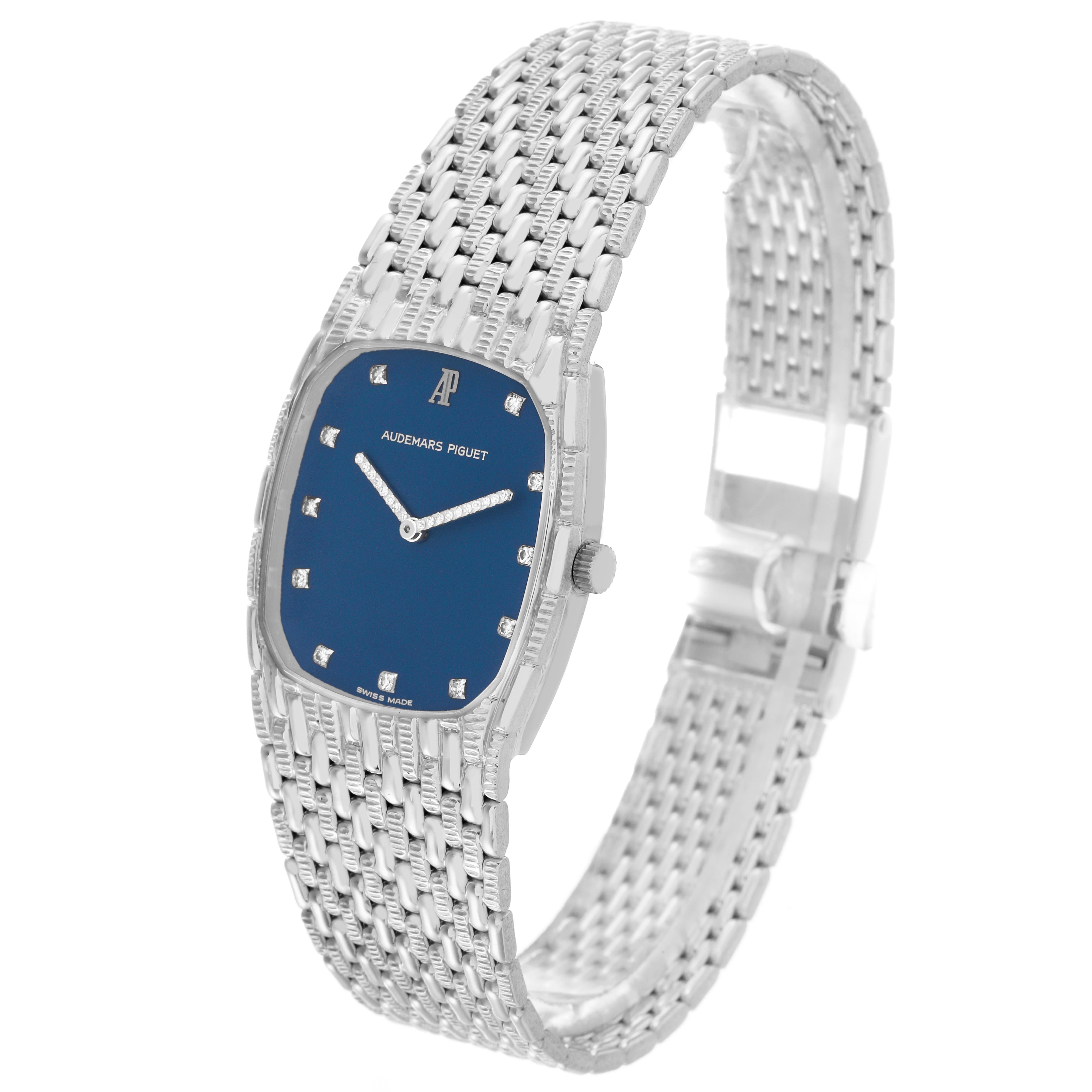 The Audemars Piguet Vintage Men's White Gold Blue Dial Men's White Gold Blue Dial watch is shown at an angled side view, highlighting its blue dial, silver bracelet, and diamond markers.