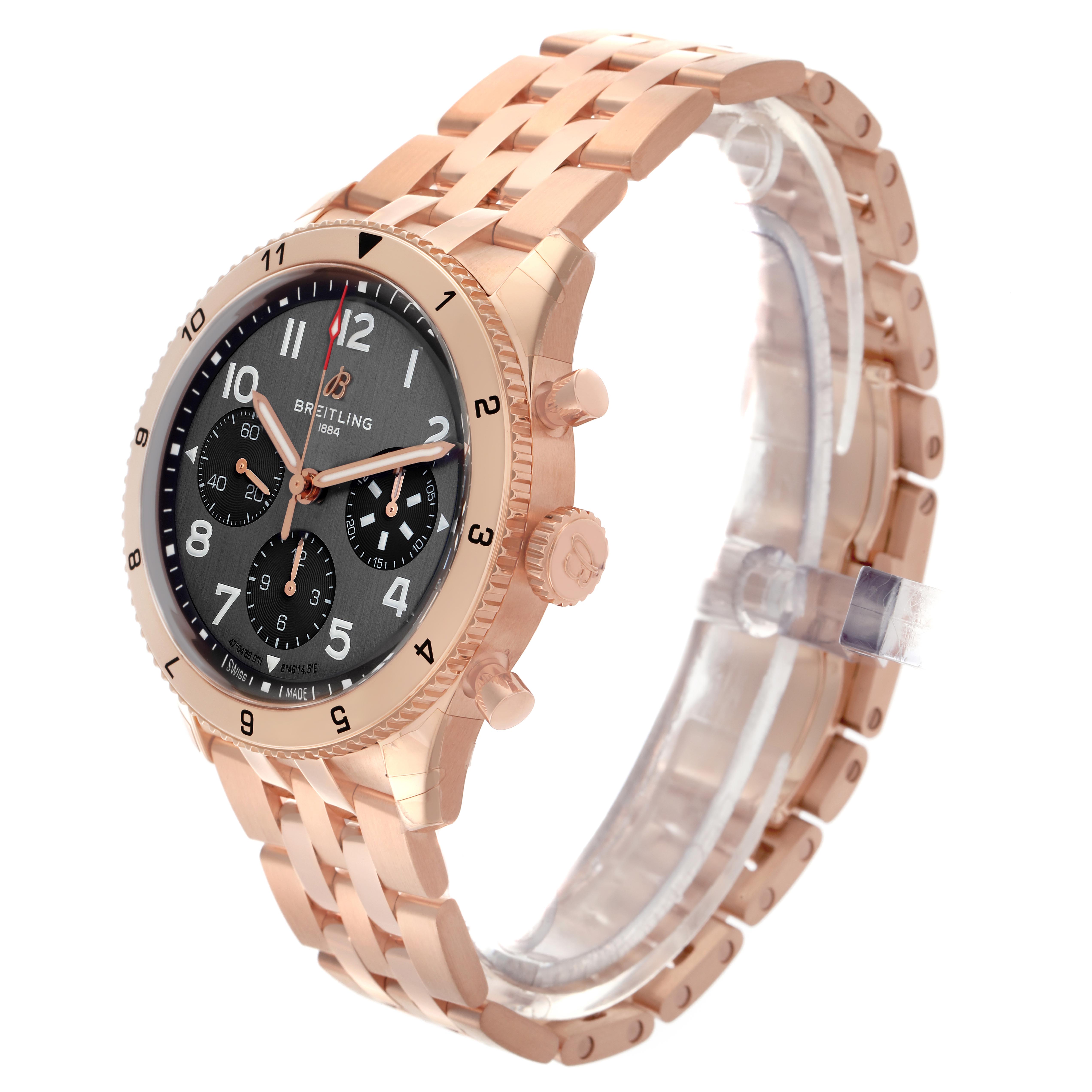 The Breitling Aviator R23380 Men's Rose Gold Grey Dial R23380 Men's Rose Gold Grey Dial watch is shown at an angled side view, displaying the gold case, bracelet, and black dial with subdials.